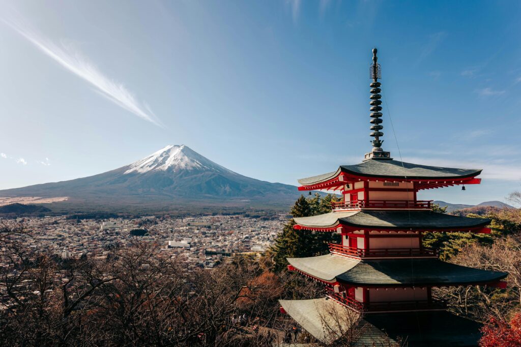 A breathtaking view of Mount Fuji alongside the iconic Chureito Pagoda under a clear sky.